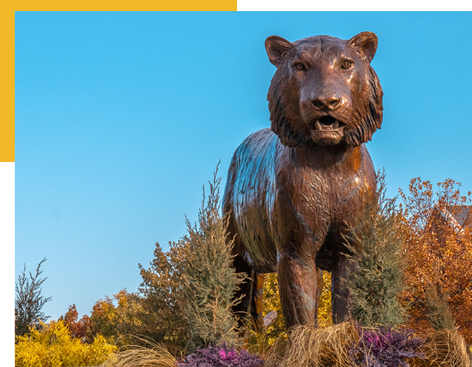 Statue in Tiger Plaza standing amid greenery