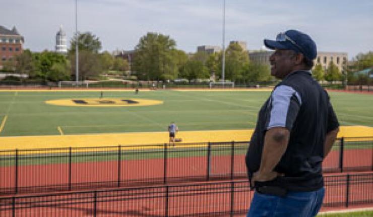 A staff member in the foreground of the image looks over Stankowski field